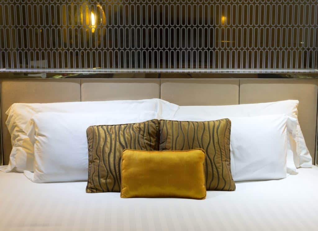 pillows on beds in hotel